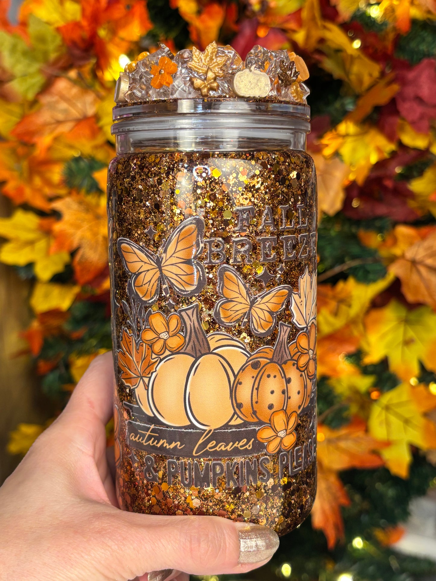 Pumpkins, leaves, and a fall breeze snow globe cup