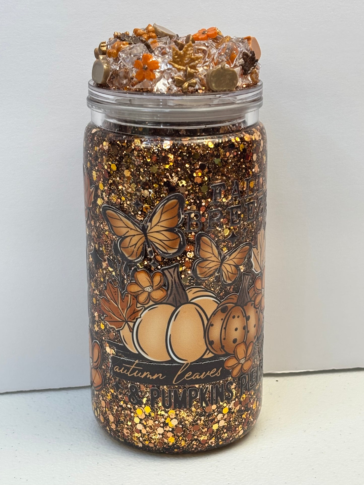Pumpkins, leaves, and a fall breeze snow globe cup