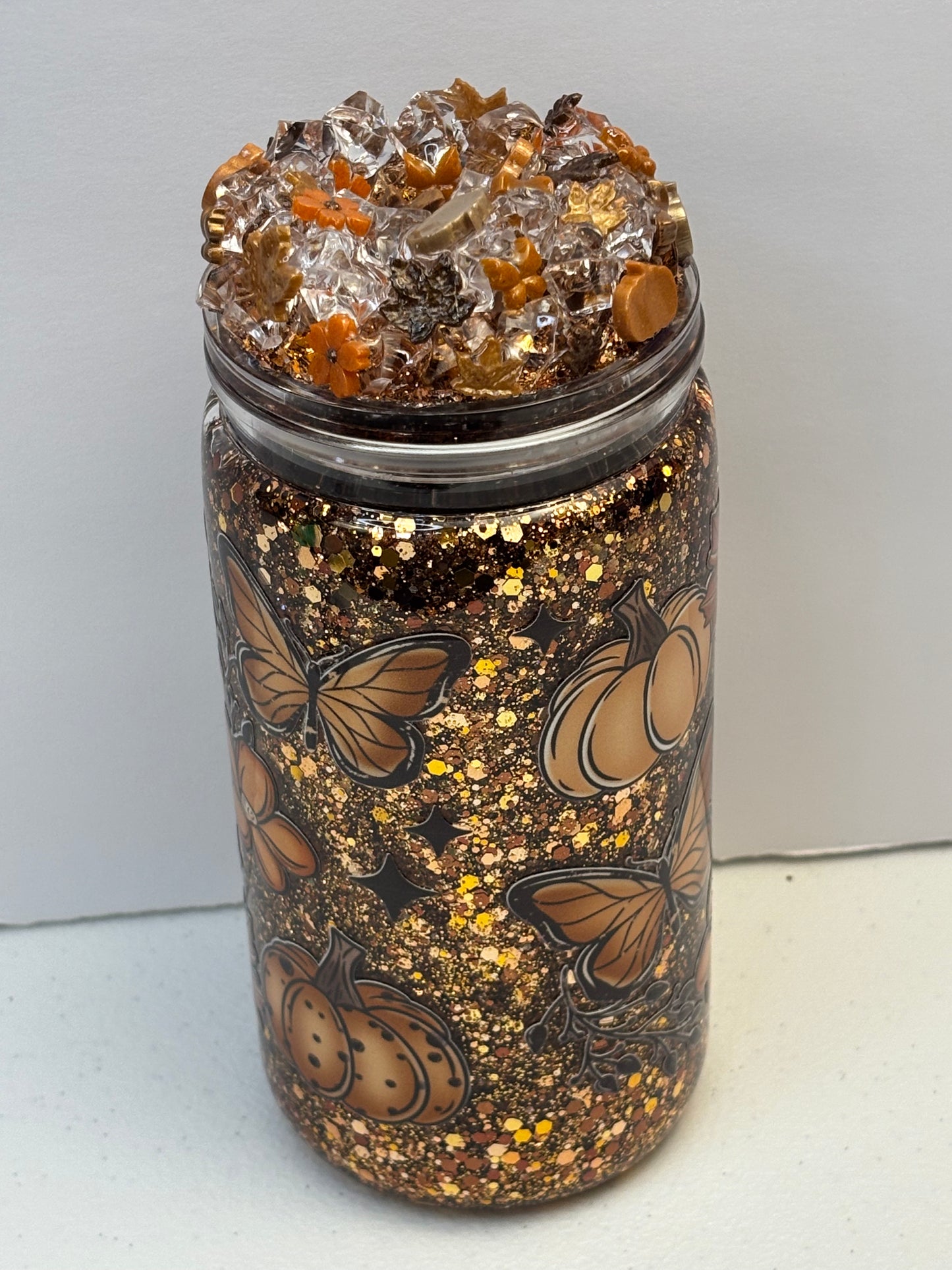 Pumpkins, leaves, and a fall breeze snow globe cup
